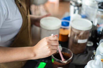 young asian girl barista is making coffee in a cafe using a drip coffee machine Produce high quality coffee 