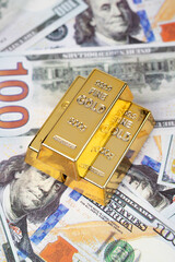 Gold bar and 100-dollar bill on a white background, symbolizing wealth, investment, and financial security