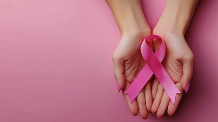 Hands Holding Pink Ribbon on Pink Background. Breast Cancer Awareness Symbol for Hope, Support, and Prevention Campaigns.