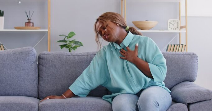 Woman lacks fresh air, feels it's difficult to breathe, can't inhale properly and starts suffocating. Woman has breathing problems because of stuffy air, summer heat or allergic anaphylaxis reaction