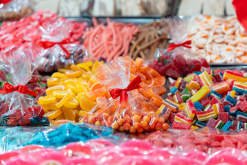 A variety of different flavors in various jellies displayed in the shop window for sale. Close-up. Sweets and candies for the holiday
