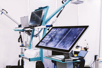 Modern portable X-ray machine with images displayed on a monitor.