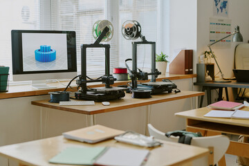 Workspace featuring multiple 3D printers actively creating intricate gears. Bright natural light streaming in through windows highlighting advanced technology