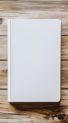 Naklejka premium Minimalist White Book on Rustic Wooden Table Surface