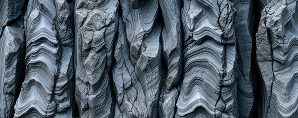 Rocky cliff crevices with rugged weathering erosion details on dark gray dolomite rock wall texture, rough fractured geological stone striations