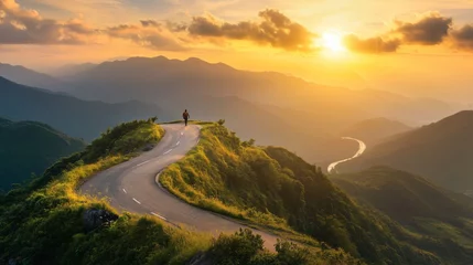A person is standing on a mountain road