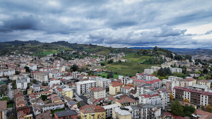 Fototapeta premium Scenic view of Alba, Italy showcasing the landscape and urban architecture under cloudy skies