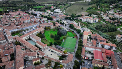Obraz premium Aerial view of Alba Italy highlighting historic buildings and green spaces in the town