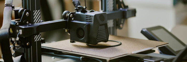 Close-up view of 3D printer fabricating an item with precision. The device showcases intricate...