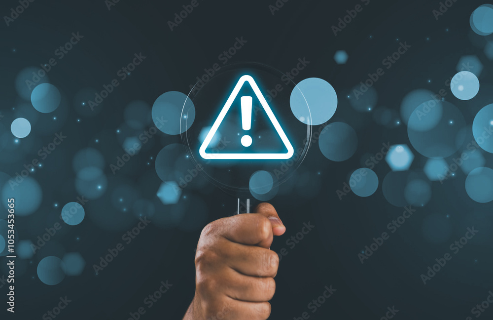 Poster Hand holding magnifier glass with red triangle caution warning sign for notification error and maintenance concept.