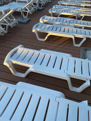 Deck chairs by an outdoor pool at a luxury resort