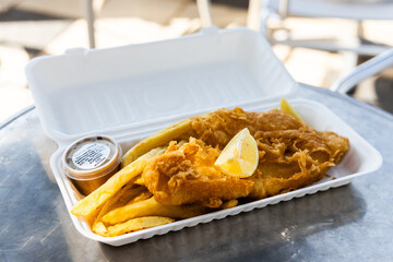 fish and chips in polystyrene takeaway box