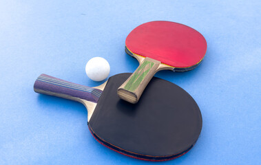 tennis rackets for playing ping pong on blue table, ping pong concept
