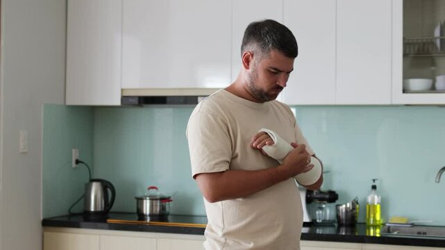 Man with broken arm is in pain.