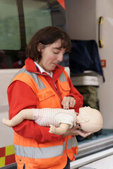 Paramedic demonstrating infant CPR on a training mannequin © ALIDA