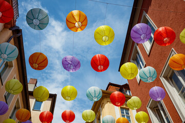 Hanging lanterns add a festive touch to delightful street scene