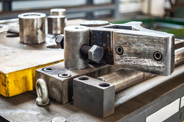 Metal bending machine for shaping steel products in industrial workshop during the daytime operation
