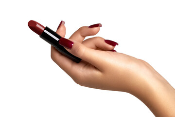 The hand with red manicure holds red lipstick, isolated on white background