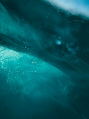 Fototapeta premium abstract blue splashes of watercolor painting on a dark background