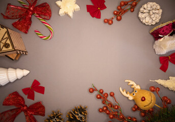 Festive Christmas background with winter holiday elements Red bows, pine cones, fir tree, candy, red berries