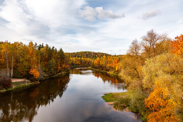 Autumn view of the river with colorful trees on the banks of the river