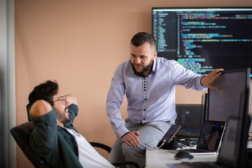 Programmers engrossed in deep collaboration, diligently working together to solve complex problems 