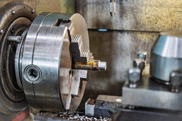 Lathe machining process in a factory showcasing precision metalworking during daytime operations