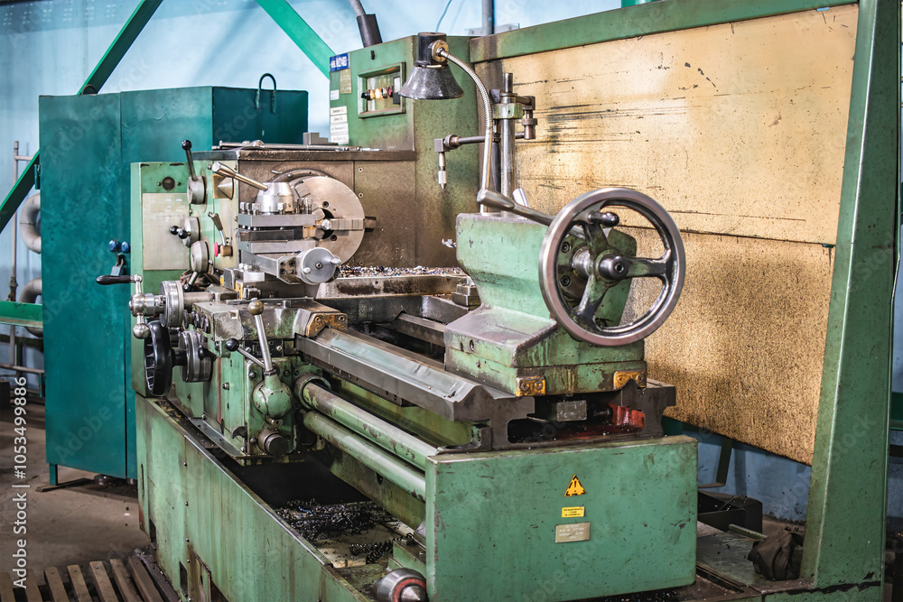 Poster a lathe operating in a factory workshop during machinery manufacturing, focusing on precision engine