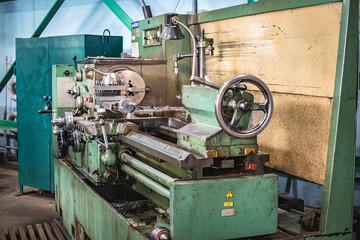 A lathe operating in a factory workshop during machinery manufacturing, focusing on precision engineering tasks and metal processing activities