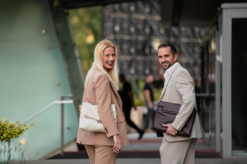 Fototapeta premium Modern business couple after a long day's work, walking together towards the comfort of their home, embodying the perfect blend of professional success and personal contentment.