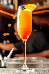 Exquisite spring mimosa or plum royal cocktail with sparkling wine or proseco wine refreshing cocktail in a luxurious bar.