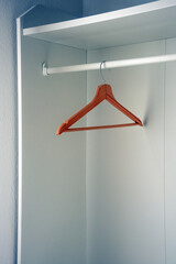 Hanger for clothes in a wooden closet