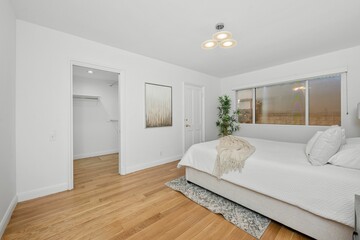 Fototapeta premium Modern minimalist bedroom with walk-in closet.