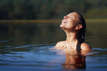 Fototapeta premium Woman in nature swimming in the lake