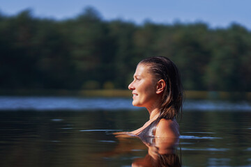 Fototapeta premium Woman in nature swimming in the lake
