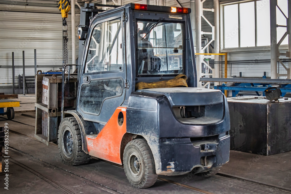 Poster forklift moving a heavy load through an industrial workshop during daylight hours for efficient mate