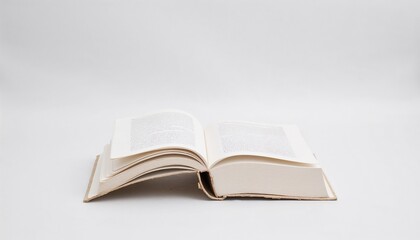 Obraz premium Open old book on a white background, promoting the idea of reading more books, knowledge and learning