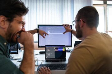 Programmers engrossed in deep collaboration, diligently working together to solve complex problems...
