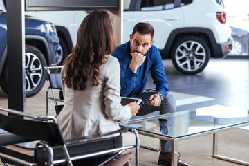 Professional Business Meeting in Modern Car Dealership Office