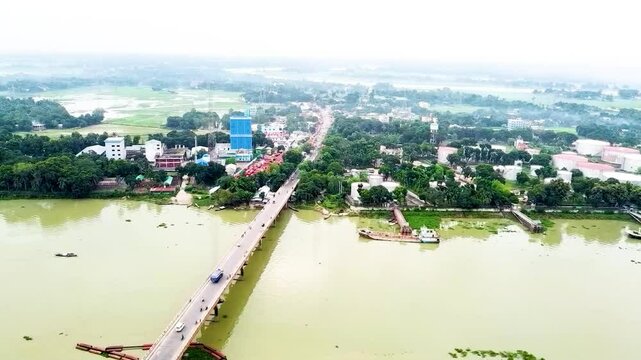 Arial drone view of river Jamuna river Bangladesh, bulkhead, ships and naval vehicles, river bankside local life