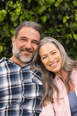 Fototapeta premium Smiling mature couple enjoying outdoor time together, embracing and looking content