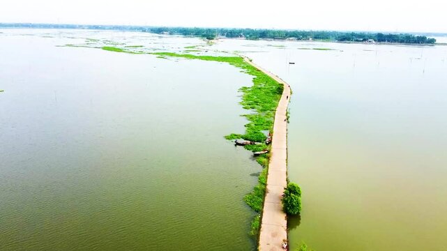 A beautiful arial drone shot, a road through the Jamuna river Bangladesh