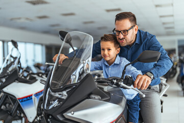 Father and Son Exploring Motorcycles at a Dealership Together