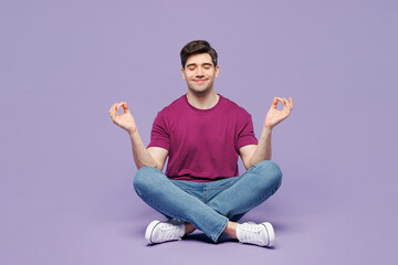 Full body young man he wear violet t-shirt casual clothes sit hold spreading hands in yoga om aum...