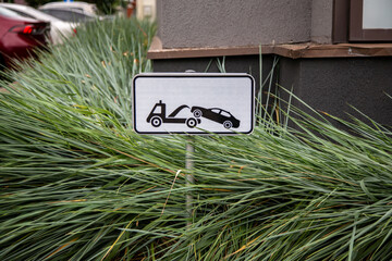 tow truck sign in urban environment. Do not park the car