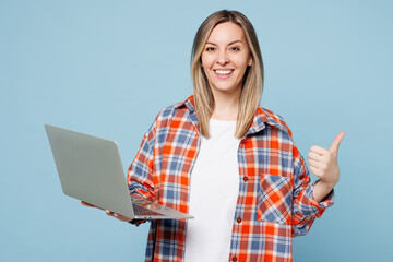 Young happy IT woman she wear red shirt t-shirt casual clothes hold use work on laptop pc computer...