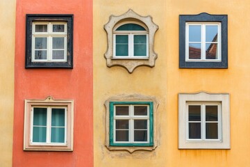 Obraz premium A colorful wall featuring six uniquely shaped windows in various styles and colors.