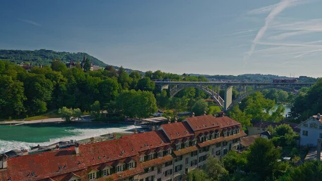 Bern medieval old town with a tramway and traditional red roofsdriving on the Kirchenfeld bridge above the Aar river in Switzerland capital city