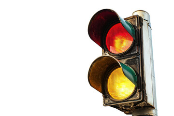 Close-up of a red and yellow traffic light against a clear sky, indicating caution and the need to stop for safety in urban environments.