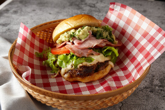Meat burger served in basket bowl with paper lining